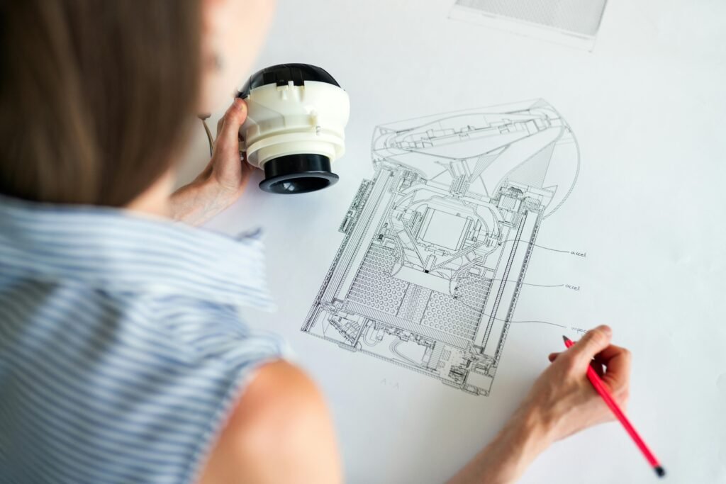 pexels-photo-3861946-3861946 Female engineer studying a detailed technical blueprint at her workspace. Concept of design and innovation.